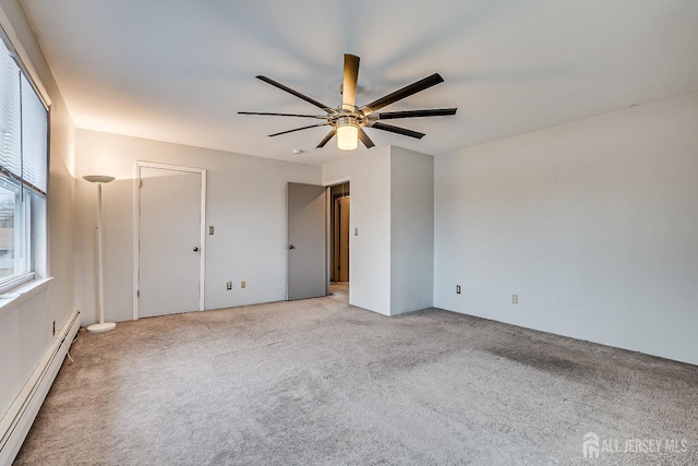 spare room featuring a baseboard heating unit, light carpet, and ceiling fan