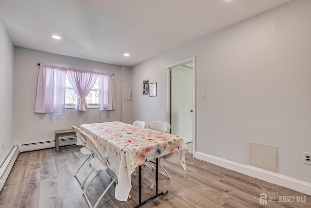 rec room with recessed lighting, baseboards, baseboard heating, and wood finished floors