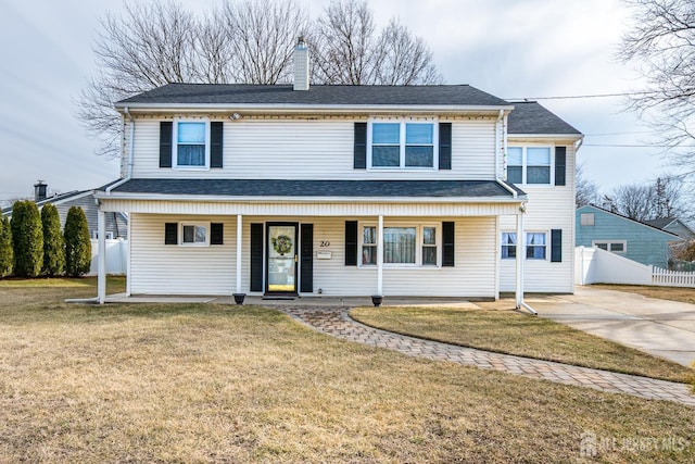 view of front of home with driveway, a chimney, fence, a porch, and a front yard