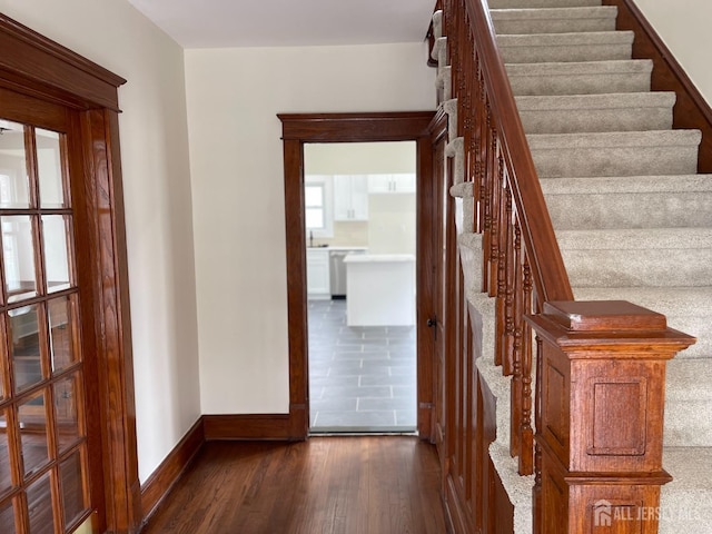 stairs featuring baseboards and wood finished floors