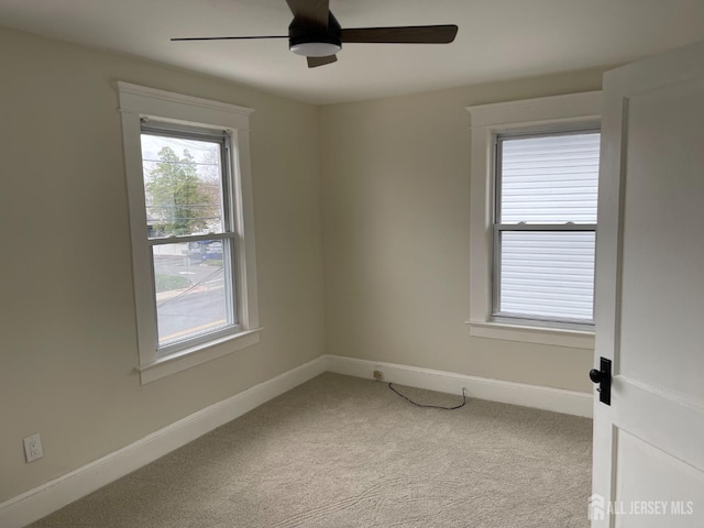 unfurnished room featuring a ceiling fan, baseboards, and carpet floors