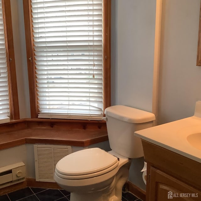 bathroom featuring toilet, tile patterned flooring, vanity, and visible vents