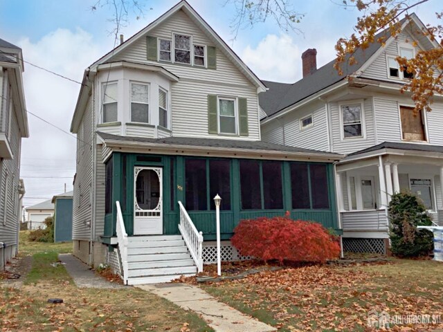 view of front of home with a sunroom