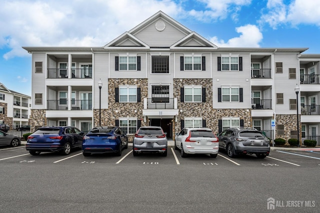 view of building exterior featuring uncovered parking