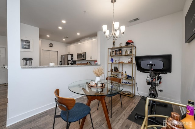 dining space featuring visible vents, baseboards, recessed lighting, and wood finished floors