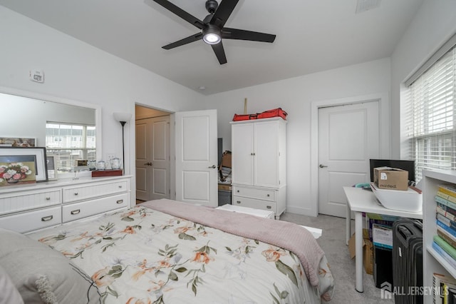 bedroom with visible vents, ceiling fan, and light carpet