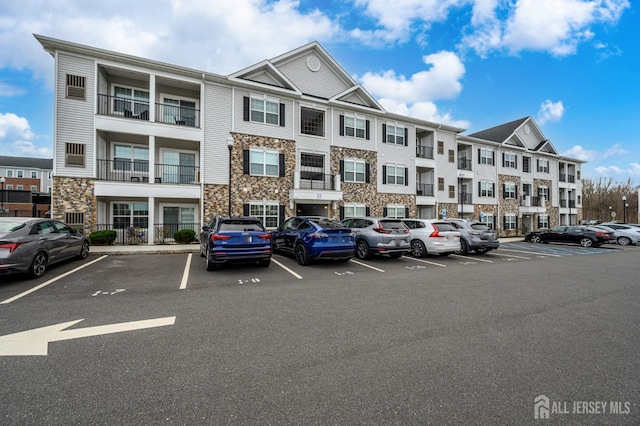 view of property with uncovered parking