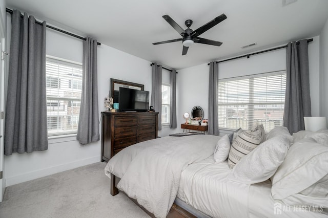 bedroom with visible vents, baseboards, multiple windows, and carpet