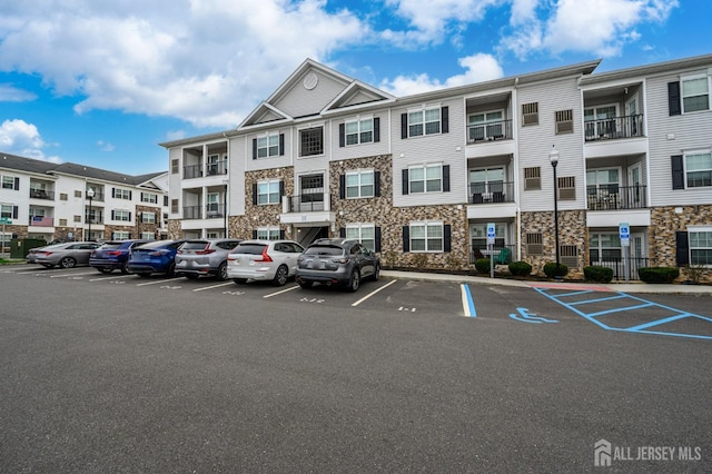 view of property featuring uncovered parking