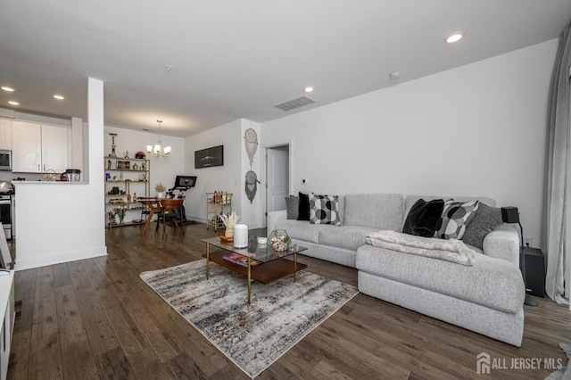 living area with a notable chandelier, dark wood finished floors, visible vents, and recessed lighting