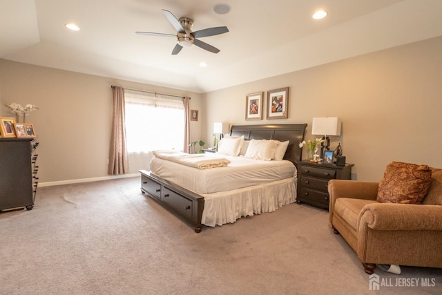 carpeted bedroom featuring baseboards, a raised ceiling, a ceiling fan, and recessed lighting