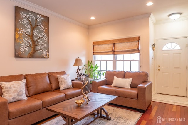 living area with ornamental molding, wood finished floors, and recessed lighting