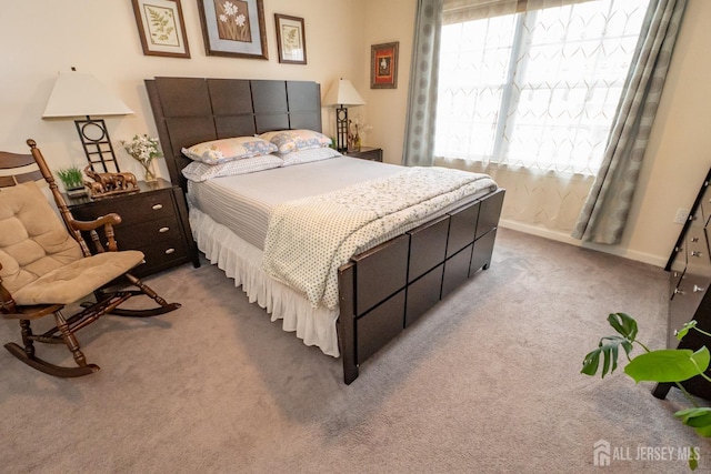 bedroom featuring carpet and baseboards