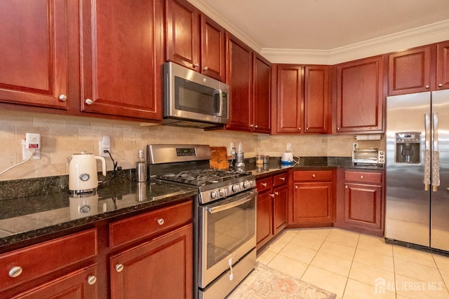 kitchen with stainless steel appliances, dark brown cabinets, light tile patterned flooring, and backsplash