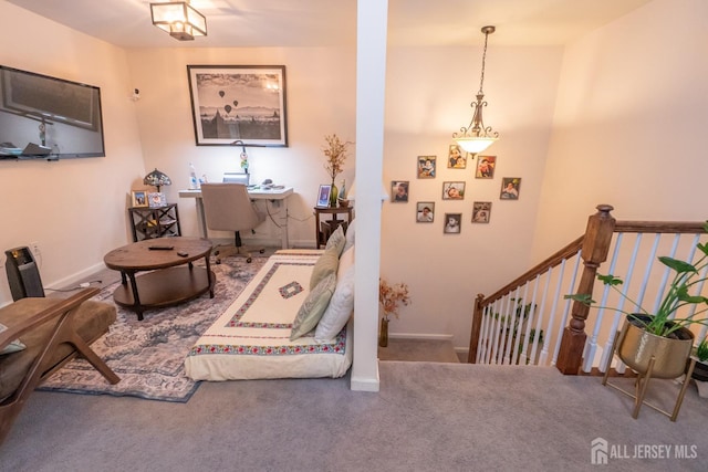 living area featuring carpet flooring, an upstairs landing, and baseboards