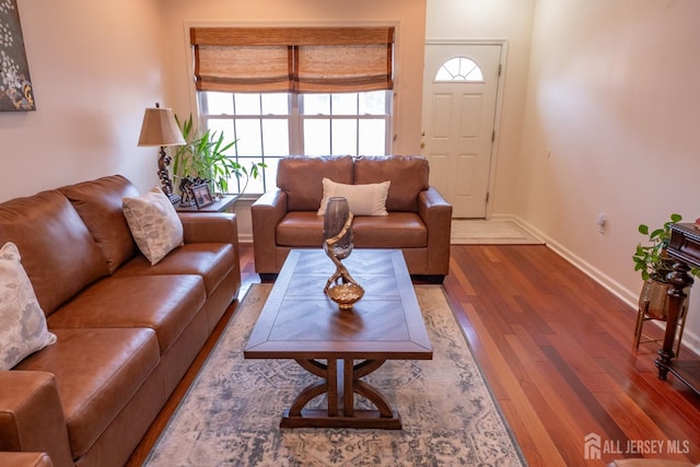 living room featuring wood finished floors and baseboards