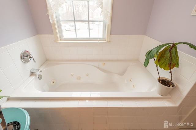 bathroom featuring a tub with jets