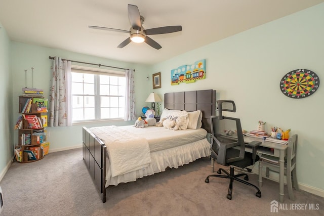 carpeted bedroom featuring a ceiling fan and baseboards