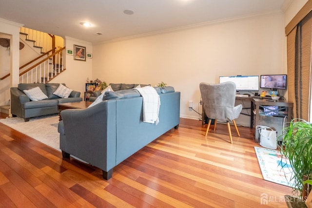 living room featuring ornamental molding, stairway, and hardwood / wood-style flooring