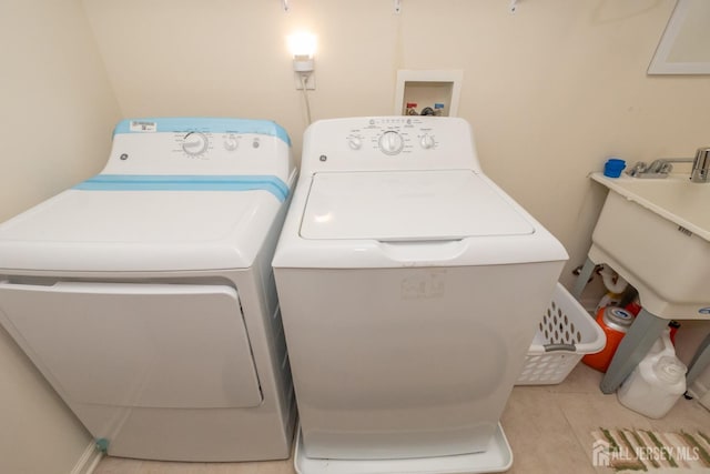 washroom with laundry area, tile patterned floors, and washing machine and clothes dryer