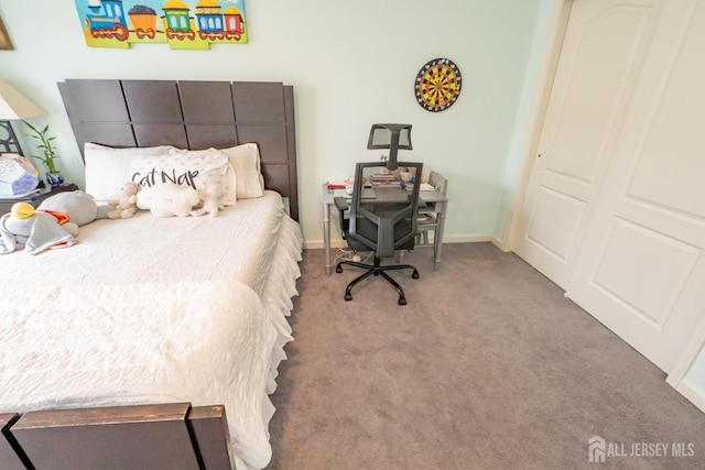 bedroom with carpet and baseboards