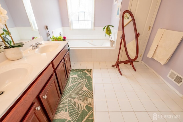 full bathroom with a garden tub, double vanity, visible vents, a sink, and tile patterned floors