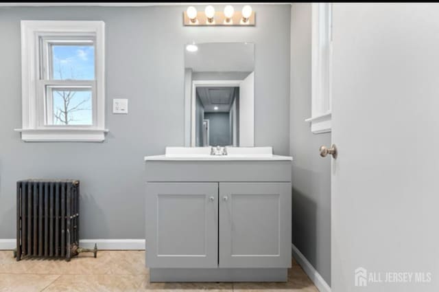 5 Warren St, Jamesburg, NJ 08831 - bathroom featuring radiator heating unit, vanity, and tile patterned floors