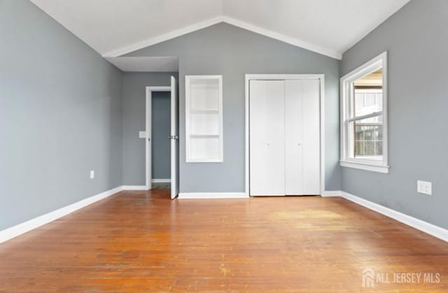 5 Warren St, Jamesburg, NJ 08831 - unfurnished bedroom with wood finished floors, vaulted ceiling, and a closet