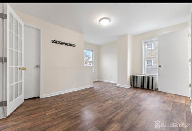 5 Warren St, Jamesburg, NJ 08831 - spare room featuring radiator heating unit and wood finished floors