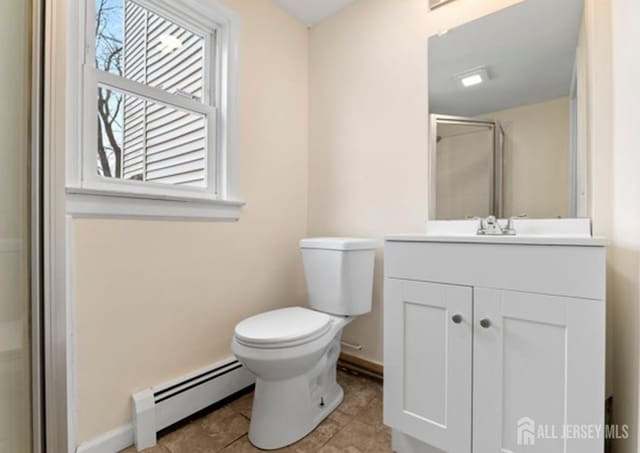 5 Warren St, Jamesburg, NJ 08831 - full bath featuring a baseboard radiator, vanity, a stall shower, and tile patterned flooring