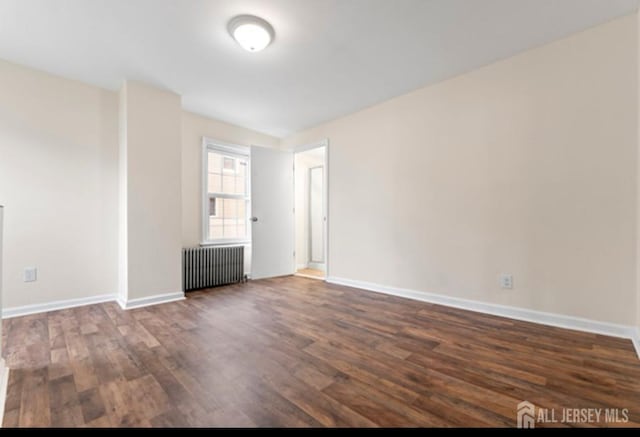 5 Warren St, Jamesburg, NJ 08831 - unfurnished room featuring radiator heating unit and dark wood-style flooring