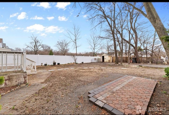 5 Warren St, Jamesburg, NJ 08831 - fenced backyard featuring a storage unit and a patio