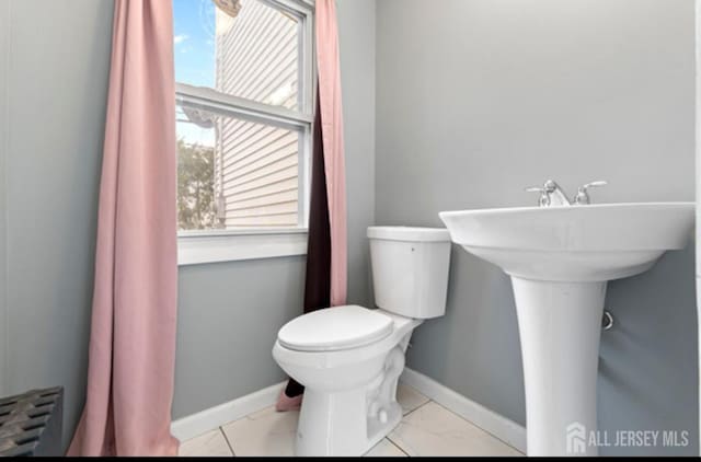 5 Warren St, Jamesburg, NJ 08831 - bathroom featuring toilet and marble look tile flooring