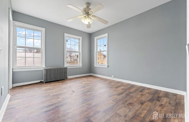 5 Warren St, Jamesburg, NJ 08831 - unfurnished room with radiator heating unit, wood finished floors, and ceiling fan