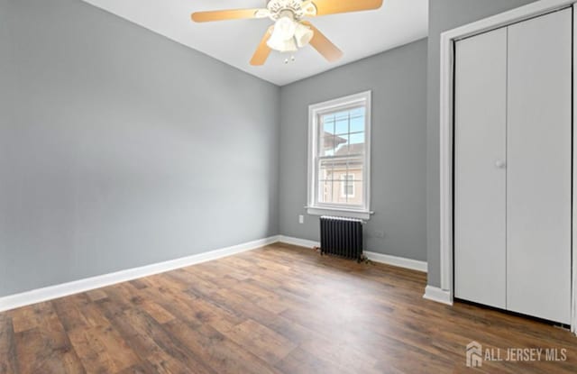 5 Warren St, Jamesburg, NJ 08831 - unfurnished bedroom featuring radiator, wood finished floors, and a closet