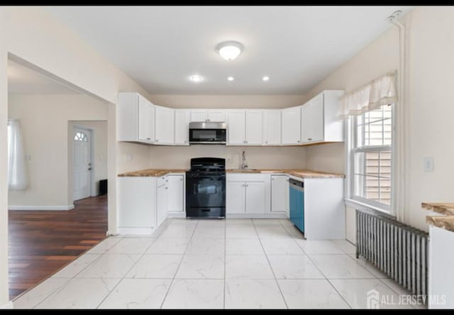 5 Warren St, Jamesburg, NJ 08831 - kitchen featuring gas range oven, stainless steel microwave, dishwasher, light countertops, and white cabinets
