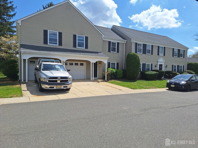 view of front of home featuring concrete driveway and an attached garage