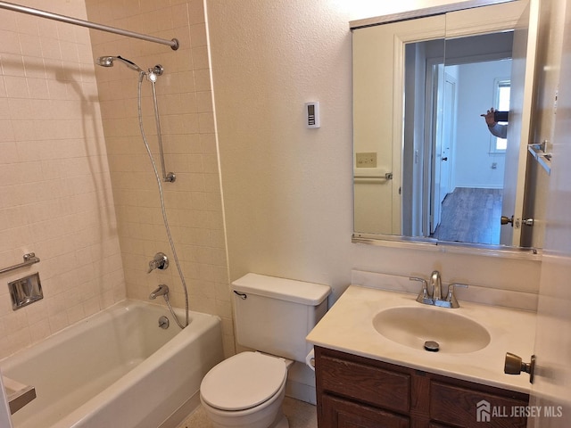 full bathroom with toilet, vanity, shower / washtub combination, and a textured wall