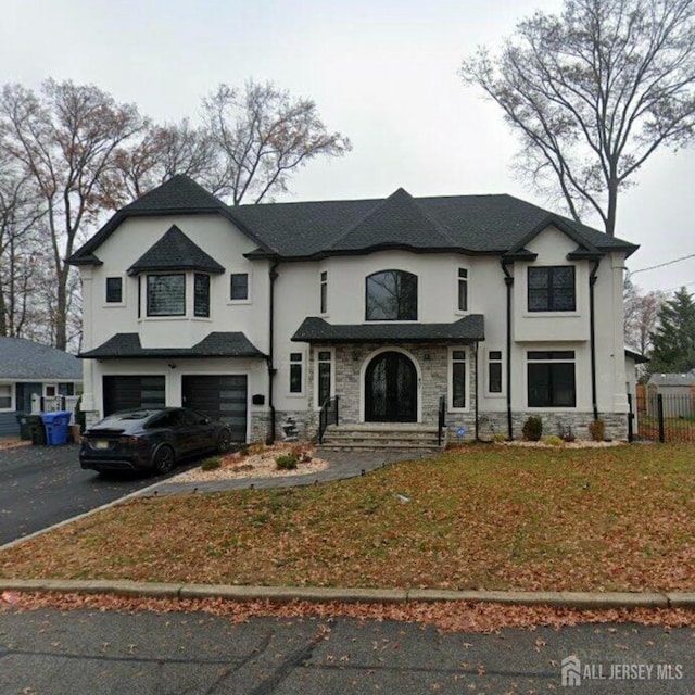 french country inspired facade featuring a garage