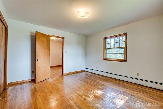 730 Old Post Rd, Edison, NJ 08817 - empty room with a baseboard radiator and light wood-style floors