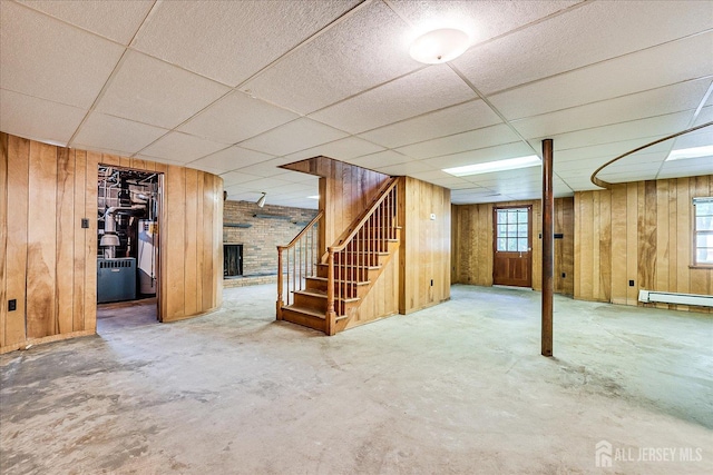 730 Old Post Rd, Edison, NJ 08817 - basement with stairway, wood walls, a fireplace, a paneled ceiling, and a baseboard radiator