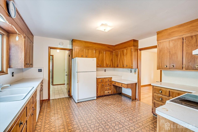 730 Old Post Rd, Edison, NJ 08817 - kitchen featuring freestanding refrigerator, light countertops, and brown cabinets