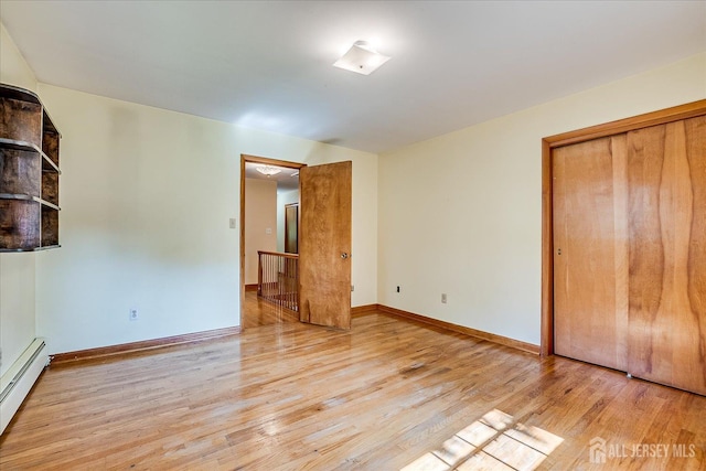 730 Old Post Rd, Edison, NJ 08817 - unfurnished bedroom featuring a baseboard radiator, wood finished floors, and a closet
