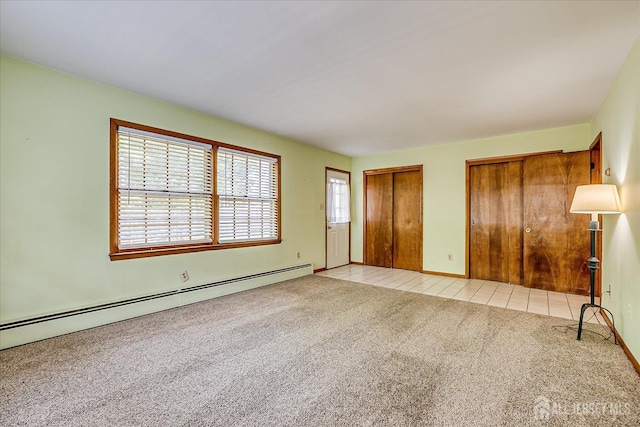 730 Old Post Rd, Edison, NJ 08817 - unfurnished bedroom with multiple closets, light colored carpet, a baseboard radiator, and light tile patterned flooring