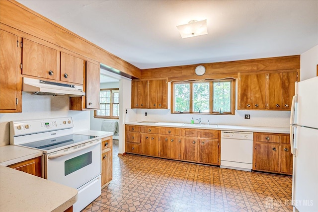 730 Old Post Rd, Edison, NJ 08817 - kitchen with white appliances, under cabinet range hood, light countertops, and brown cabinets