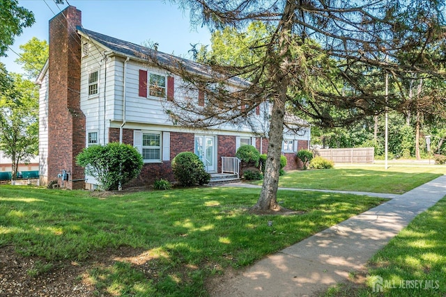 730 Old Post Rd, Edison, NJ 08817 - colonial inspired home with a chimney, a front yard, and brick siding