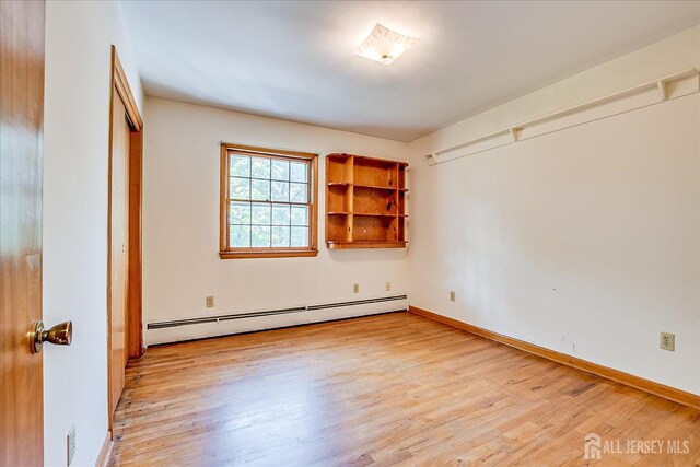730 Old Post Rd, Edison, NJ 08817 - unfurnished room with a baseboard radiator and light wood-style flooring