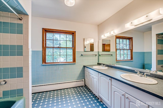 730 Old Post Rd, Edison, NJ 08817 - full bathroom with a baseboard heating unit, tile walls, double vanity, a tub to relax in, and wainscoting