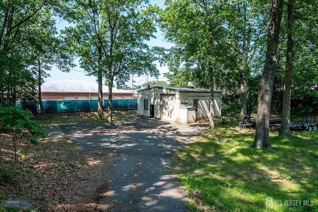 730 Old Post Rd, Edison, NJ 08817 - view of front of house featuring asphalt driveway, concrete block siding, and a shed