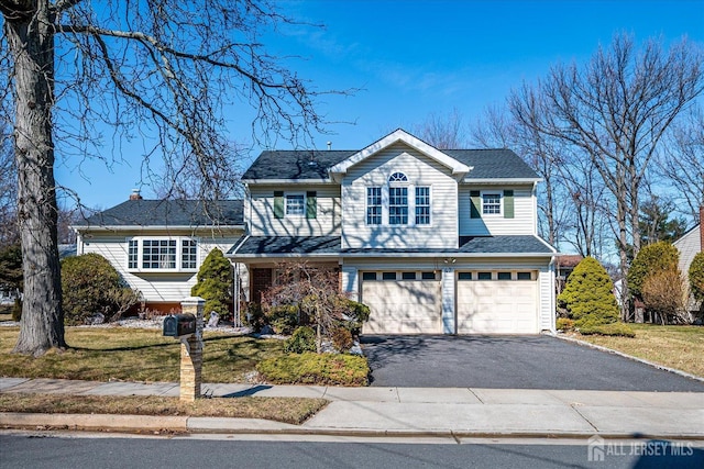 traditional home featuring driveway and an attached garage